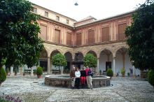 What a group in front of the fountain in the patio of the Abadia in Sacramonte.