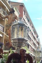 Close up of another part of the paso.  More wood carving visible and one of the enclosed detailed silver candle holders.