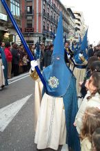 Penitente with long candle.