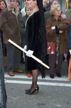 It is amazing how these woman and stand, let alone walk for hours on some of these streets )this one happens to be one of the major streets in town so it has asphalt.  Notice also the lace gloves.